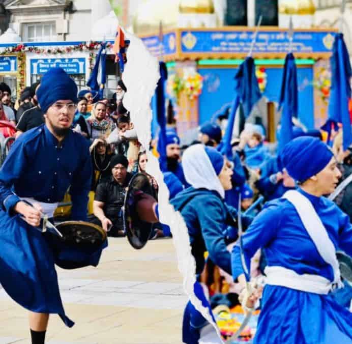 Photograph of Sikh Vaisakhi celebration participants dressed in blue in public space