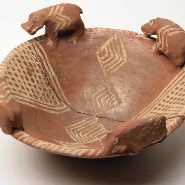 Brown ceramic bowl with four hippos standing on it's rim